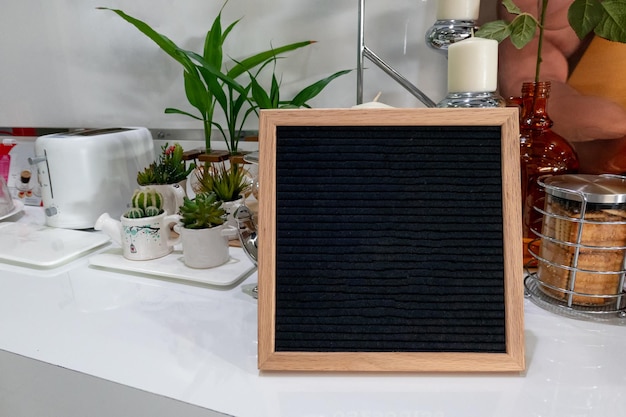 Wooden frame black background on the table with plant and bread in lounge