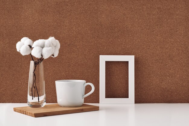 Wooden frame, cotton vase and white cup