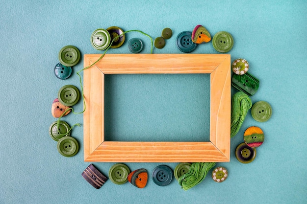 Wooden frame and green buttons copy space sewing kit