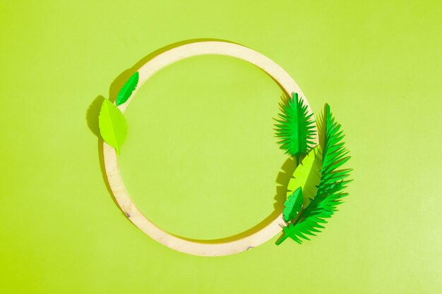 Wooden frame with tropical leaves with copy space top view