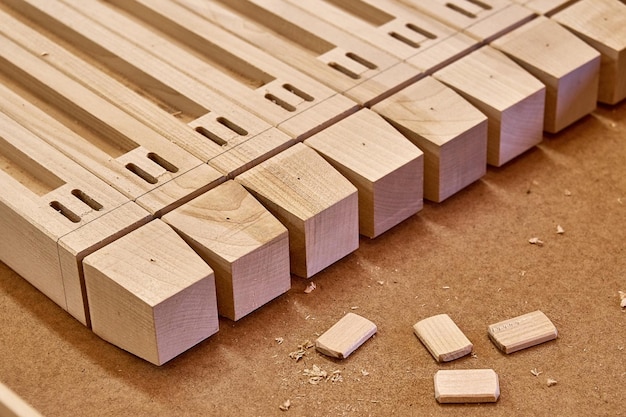 Wooden furniture legs folded on workbench in workshop Furniture details closeup