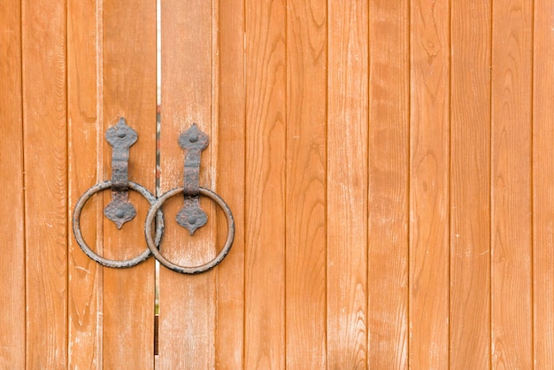 Wooden gate with round metal handles background