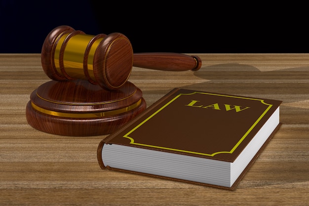 Wooden gavel and book on table