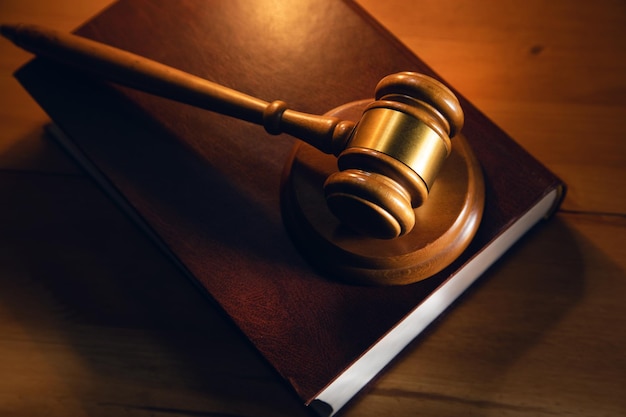 Wooden gavel and book on the wooden table