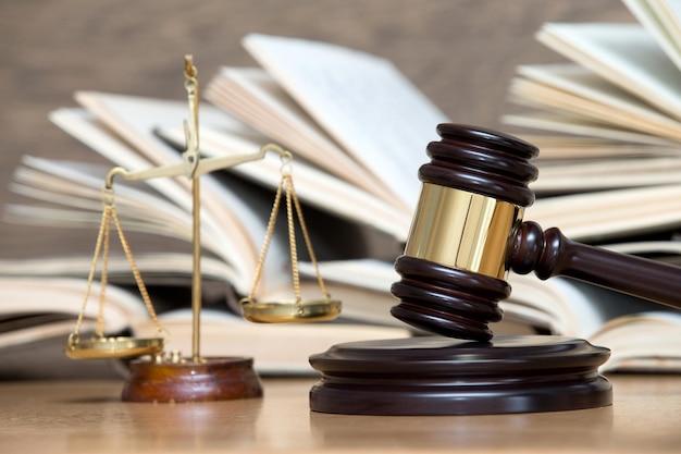 Wooden gavel and books on wooden table