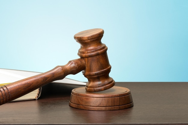 Wooden gavel and books on wooden table