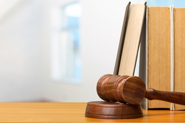 Wooden gavel and books on wooden table