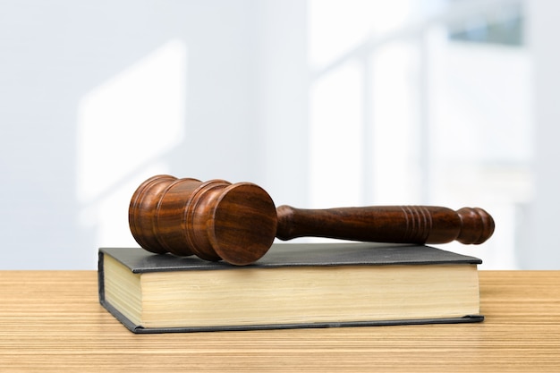 Wooden gavel and books on wooden table