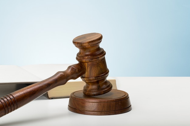 Wooden gavel and books on wooden table