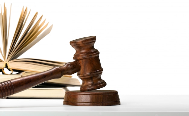 Wooden gavel and books on wooden table