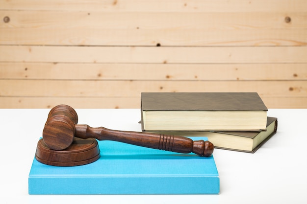 Wooden gavel and books on wooden table