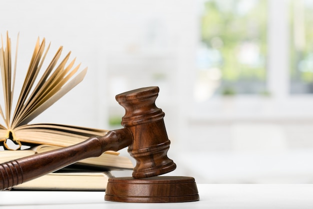 Wooden gavel and books on wooden table