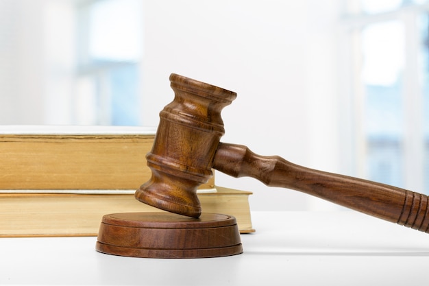 Wooden gavel and books on wooden table