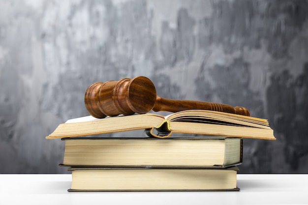 Wooden gavel and books on wooden table