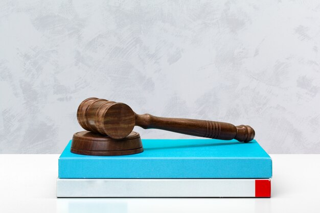 Wooden gavel and books on wooden table