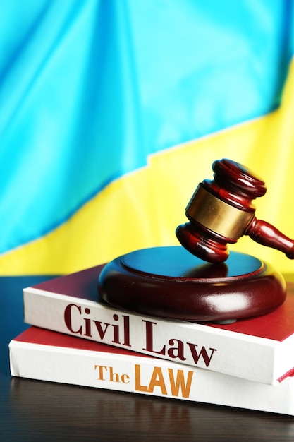 Wooden gavel and flag of ukraine as background