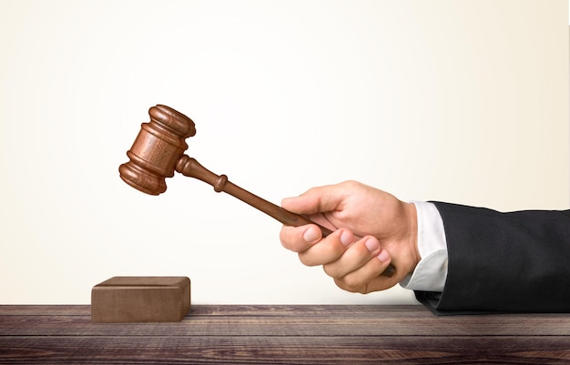 Wooden gavel in hand close-up view