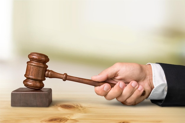 Wooden gavel in hand, close-up view