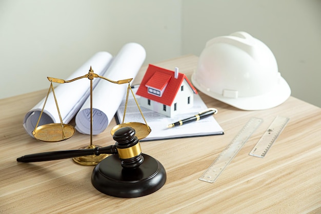 Wooden gavel house and yellow helmet