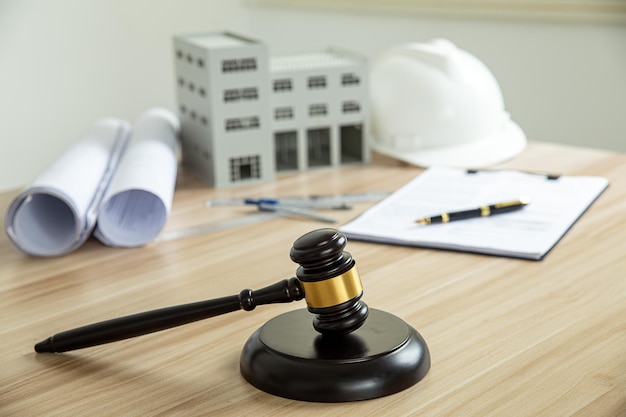 Wooden gavel house and yellow helmet