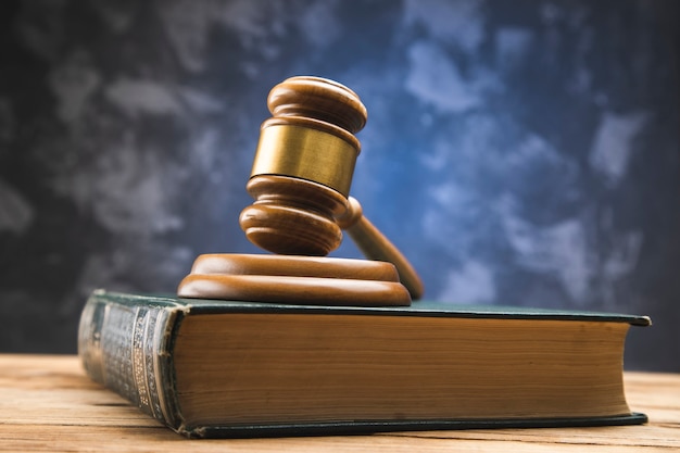 Wooden gavel on law book on wooden table