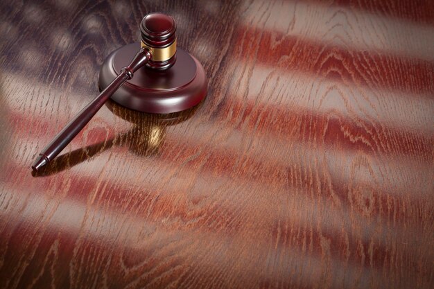 Wooden Gavel Resting on American Flag Reflecting Table