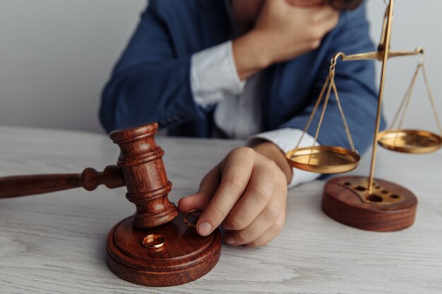 Wooden gavel and rings closeup Divorce and separation concept