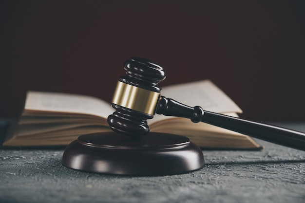 Wooden gavel on the table with notary books.