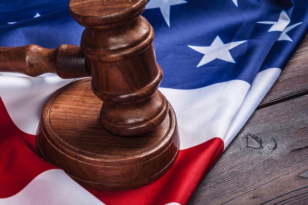 Photo wooden gavel and usa flag on table close up