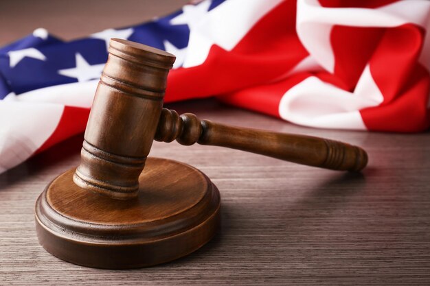 Wooden gavel and USA flag on table