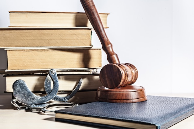 Wooden gavel with pile of books