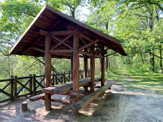 Wooden gazebo for vacationers in the forest