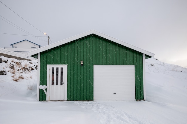 Wooden green house with snow covered in snowing on winter at scandinavia