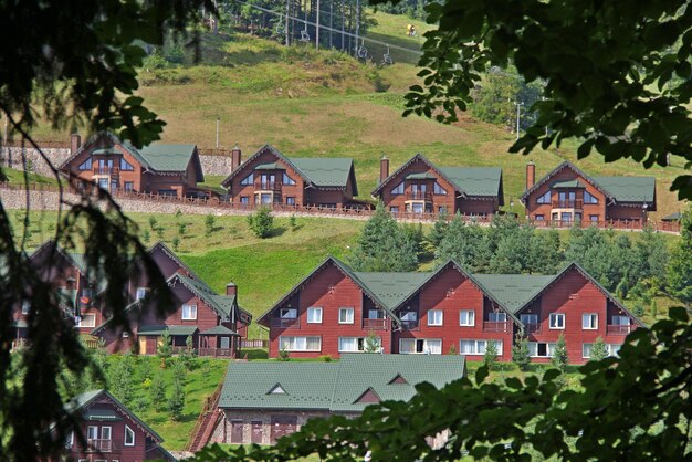 Wooden Guest Cottages On A Hill At Mountain Resort