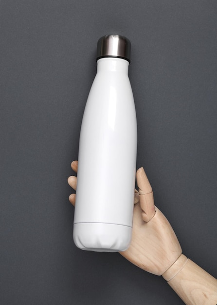 Wooden hand holding White metal thermal bottle for water on white background Stainless Steel Vacuum Insulated thermos Bottle