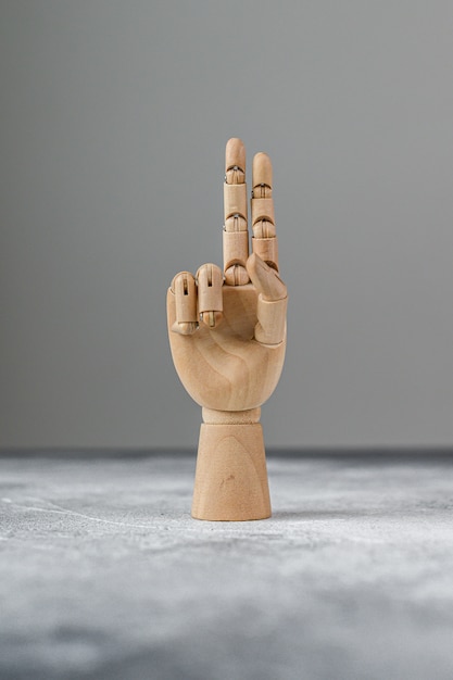 The wooden hand shows two raised fingers. the concept of communication.