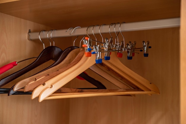 Wooden hangers in the wardrobe closeup