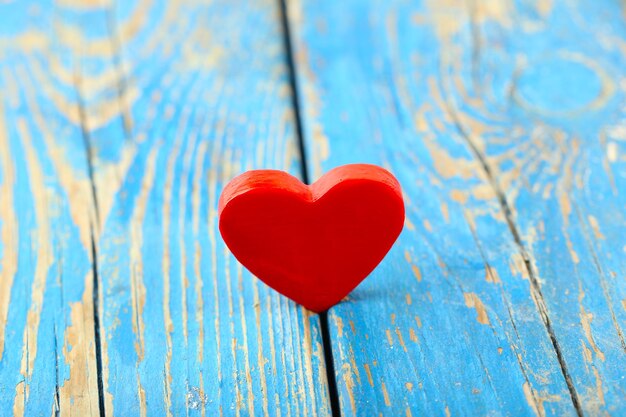 Wooden heart on color wooden background