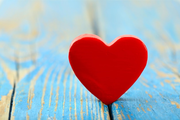 Wooden heart on color wooden background