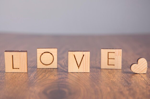 Wooden heart and love on wooden cubes