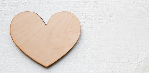 wooden heart on the white table. Valentine concept background