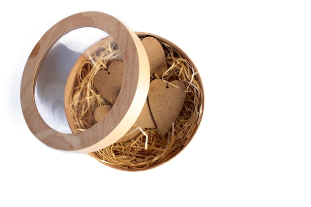 Wooden hearts in a basket Close up on a white background