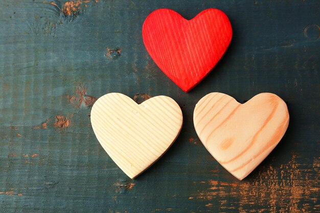 Wooden hearts on color wooden background