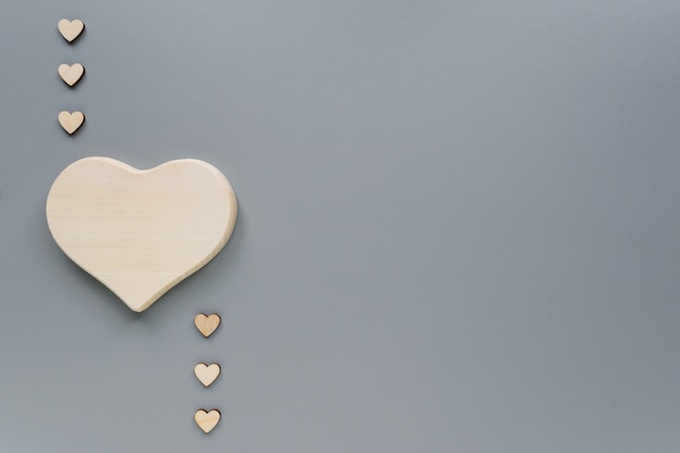 Wooden hearts on grey with copy space