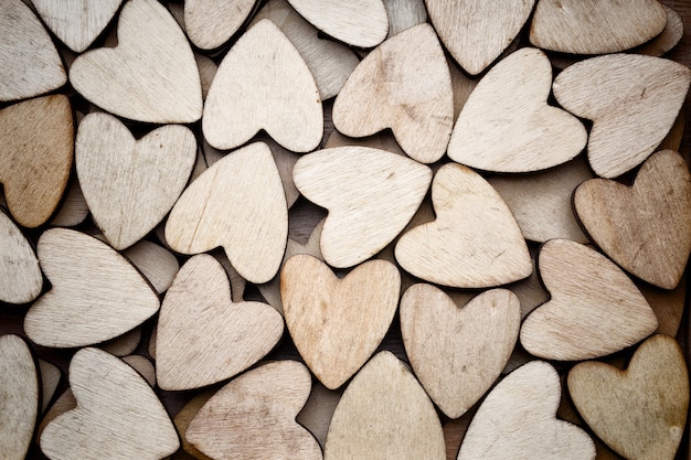 Wooden hearts, on the heart background.