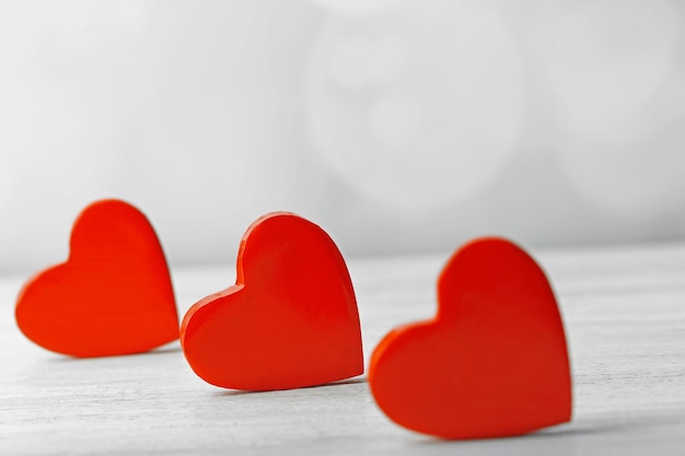 Wooden hearts on light background