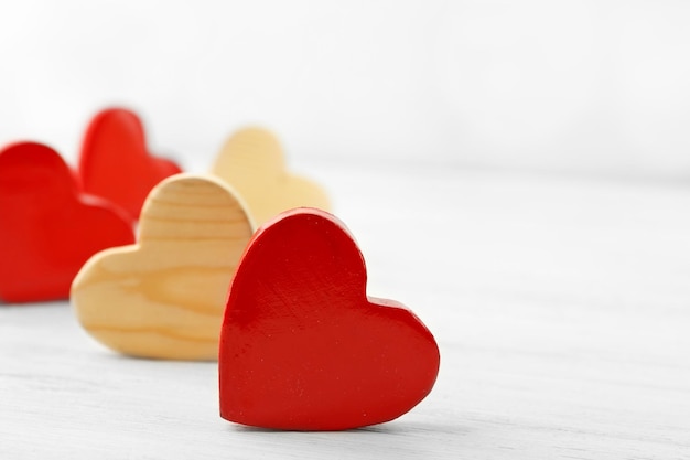 Wooden hearts on light background