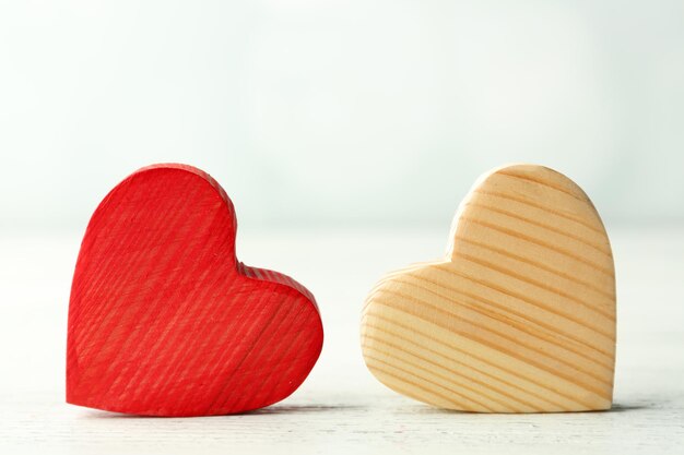 Wooden hearts on light background