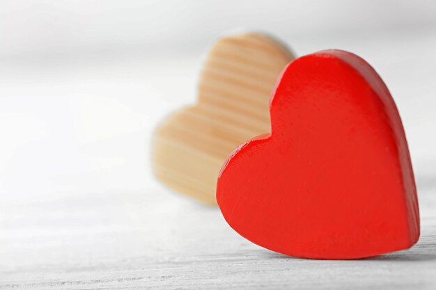 Wooden hearts on light background