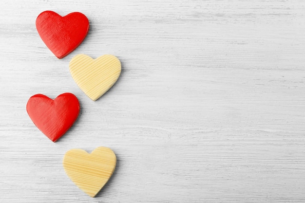 Wooden hearts on light background